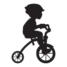 Silhouette of a boy riding a tricylce