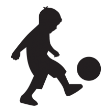 Silhouette of boy kicking ball