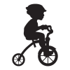 Silhouette of a boy riding a tricylce