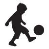 Silhouette of boy kicking ball